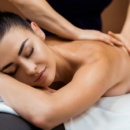 beautiful young woman with closed eyes having massage in spa