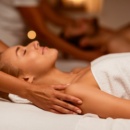Woman Enjoying Massage During Couples Beauty Treatment Lying At Spa